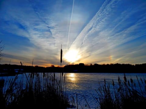 A gloriole or icebow with aircraft contrails