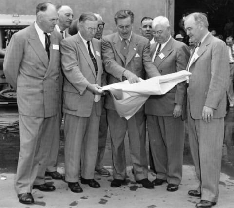 Walt Disney shows Disneyland plans to Orange County officials in December 1954.