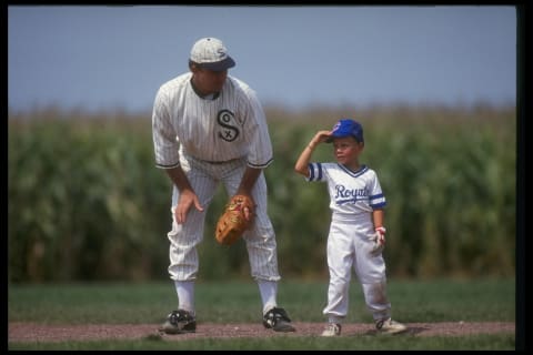 DYERSVILLE, IA – AUGUST 25: A ‘ghost player’ recreating the role of Chicago White Sox legend Shoeless Joe Jackson plays ball with a young tourist at the baseball field created for the motion picture ‘Field of Dreams’ on August 25, 1991 in Dyersville, Iowa. Rita and Al Ameskamp who, with Don and Becky Lansing, co-own the site have turned the cornfields and baseball diamond into a summertime tourist attraction, including ‘ghost player’ reenactments. (Photo by Jonathan Daniel/Getty Images)