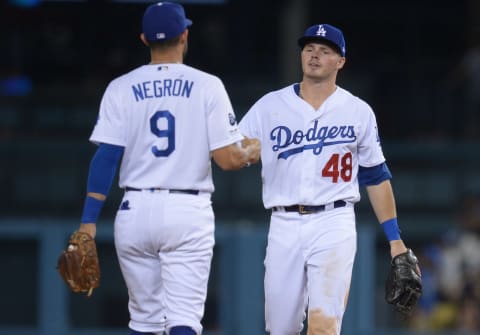 September 2, 2019; Los Angeles, CA, USA; Los Angeles Dodgers second baseman Gavin Lux (48) and third baseman Kristopher Negron (9) celebrate the 16-9 victory against the Colorado Rockies at Dodger Stadium. Mandatory Credit: Gary A. Vasquez-USA TODAY Sports