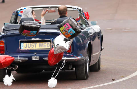 Prince William and Kate Middleton drive away from Buckingham Palace on their wedding day.