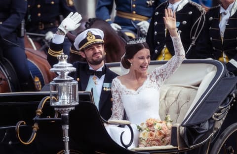 Prince Carl Philip of Sweden and his wife Princess Sofia ride in a carriage on their wedding day.