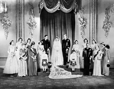 Members of the British Royal family and guests pose around Princess Elizabeth (future Queen Elizabeth II) and Philip, Duke of Edinburgh.