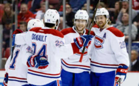 Apr 8, 2017; Detroit, MI, USA; Montreal Canadiens defenseman Nathan Beaulieu (center) receives congratulations from teammates after scoring in the second period against the Detroit Red Wings at Joe Louis Arena. Mandatory Credit: Rick Osentoski-USA TODAY Sports