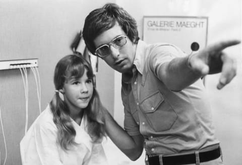 William Friedkin discusses a scene with Linda Blair during the making of The Exorcist (1973).