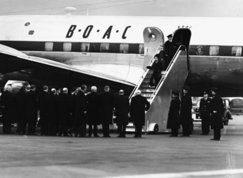 Queen Elizabeth II and Prince Philip, the Duke of Edinburgh, leaving their airplane as they return from Kenya following the death of King George VI in February 1952.