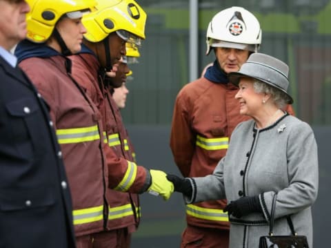 Queen Elizabeth II meets trainee firefighters as she tours the new London Fire Brigade Headquarters at Southwark in February 2008.