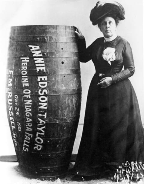 Annie Edson Taylor, the first person who'd survived a trip over Niagara Falls in a barrel, poses with her vehicle.