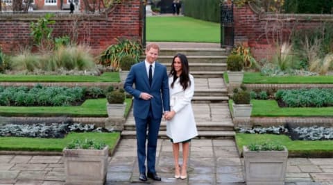 Prince Harry and Meghan Markle pose for a photograph in the Sunken Garden at Kensington Palace in west London on November 27, 2017, following the announcement of their engagement