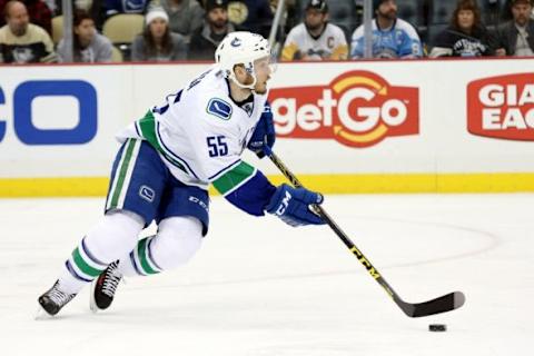 Jan 23, 2016; Pittsburgh, PA, USA; Vancouver Canucks defenseman Alex Biega (55) moves the puck against the Pittsburgh Penguins during the second period at the CONSOL Energy Center. Mandatory Credit: Charles LeClaire-USA TODAY Sports