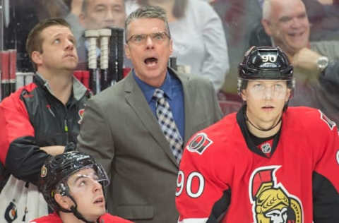 Feb 8, 2016; Ottawa, Ontario, CAN; Ottawa Senators head coach Dave Cameron (C) reacts to a call from behind the bench in the second period against the Tampa Bay Lightning at the Canadian Tire Centre. Mandatory Credit: Marc DesRosiers-USA TODAY Sports