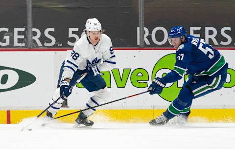 VANCOUVER, BC – APRIL 18: William Nylander #88 of the Toronto Maple Leafs looks to make a pass while pressured by Tyler Myers #57 of the Vancouver Canucks during NHL hockey action at Rogers Arena on April 17, 2021 in Vancouver, Canada. (Photo by Rich Lam/Getty Images)