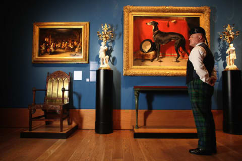 A member of staff at the Queens Gallery views a painting in the Royal Collection on March 13, 2012 in Edinburgh, Scotland