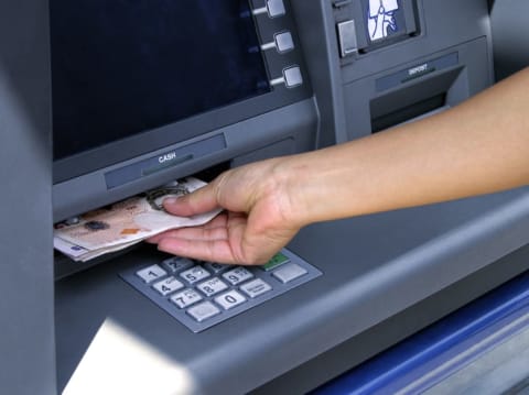 Person getting cash from an ATM.