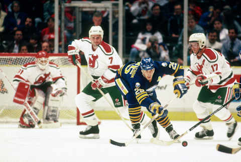 EAST RUTHERFORD, NJ – CIRCA 1990: Dave Andreychuk #25 of the Buffalo Sabers skates against the New Jersey Devils during an NHL Hockey game circa 1990 at the Brendan Byrne Arena in East Rutherford, New Jersey. Andreychuk’s playing career went from 1982-2006. (Photo by Focus on Sport/Getty Images)