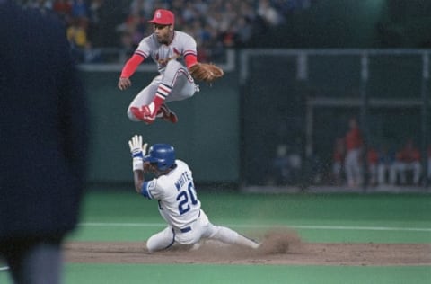 St. Louis Cardinals’ short stop Ozzie Smith leaps to catch a wild throw as the Kansas City Royals’ Frank White steals second base in the second inning of game two of the 1985 World Series. The Cardinals won the game 4-2.