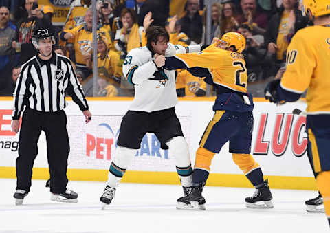 Apr 12, 2022; Nashville, Tennessee, USA; San Jose Sharks defenseman Nicolas Meloche (53) and Nashville Predators center Nick Cousins (21) fight during the second period at Bridgestone Arena. Mandatory Credit: Christopher Hanewinckel-USA TODAY Sports