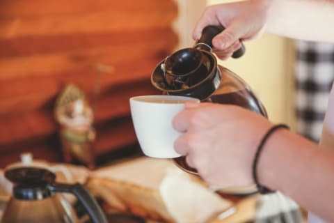 hands pouring coffee