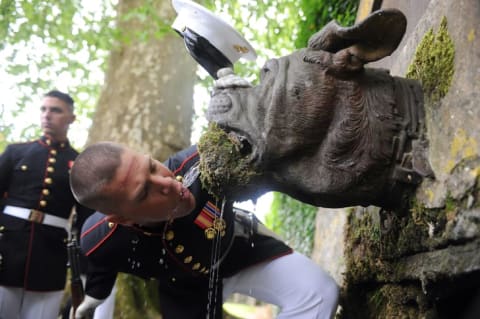 Lance Cpl. Seth H. Capps, a member of the United States Marine Corps Silent Drill Platoon, drinks out of Devil Dog Fountain following the 93rd anniversary of the Battle of Belleau Wood, May 30, 2010.