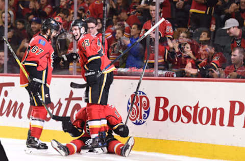 Dec 2, 2016; Calgary, Alberta, CAN; Calgary Flames right wing Kris Versteeg (10) celebrates his first period goal withright wing Michael Frolik (67) and center Sean Monahan (23) against the Minnesota Wild at Scotiabank Saddledome. Mandatory Credit: Candice Ward-USA TODAY Sports