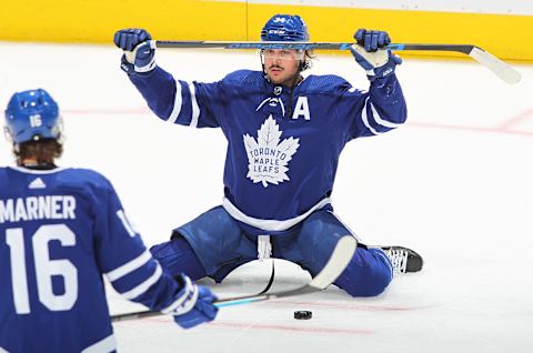 Auston Matthews #34 of the Toronto Maple Leafs stretches with his CCM Jetspeed stick over his head (Photo by Claus Andersen/Getty Images)