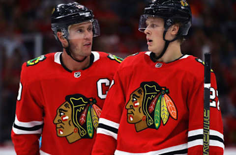 CHICAGO, ILLINOIS – SEPTEMBER 18: Jonathan Toews #19 of the Chicago Blackhawks (L) talks with Adam Boqvist #27 during a preseason game against the Detroit Red Wings at the United Center on September 18, 2019 in Chicago, Illinois. The Blackhawks defeated the Red Wings 2-1. (Photo by Jonathan Daniel/Getty Images)