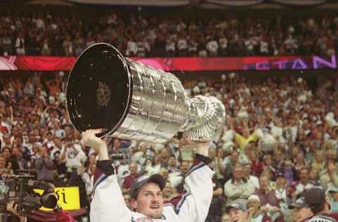 Czech professional hockey player Milan Hejduk of the Colorado Avalanche hoists the Stanley Cup over his head in celebration of their championship victory over the New Jersey Devils, Denver, Colorado, June 9, 2001. (Photo by Jim McIsaac/Getty Images)