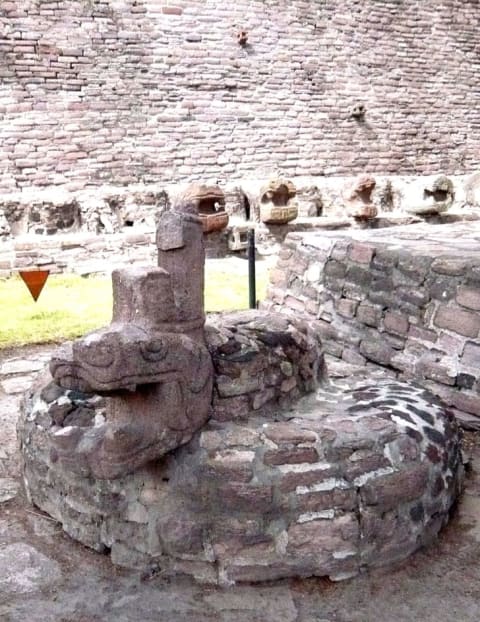 A stone statue of Xiuhcoatl at an Aztec site in Tenayuca, Mexico