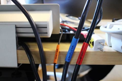 Electronics cords wrapped in labeled straws.