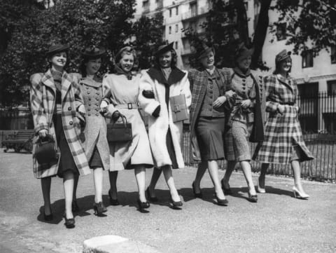 A group of models wearing new fashions for American women preview the collection in August 1940.