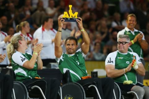 An Invictus Games athlete holds up a trophy