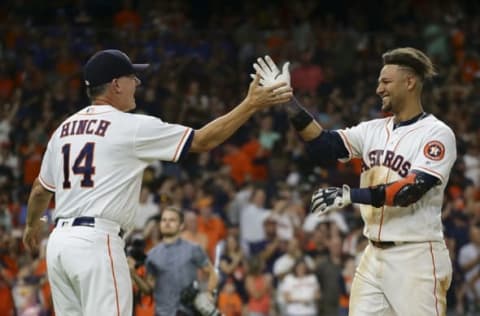 HOUSTON, TX – JULY 05: Yuli Gurriel #10 of the Houston Astros receives a high five from manager manager AJ Hinch #14 after singling in the winning run in the ninth inning against the Chicago White Sox at Minute Maid Park on July 5, 2018 in Houston, Texas. (Photo by Bob Levey/Getty Images)