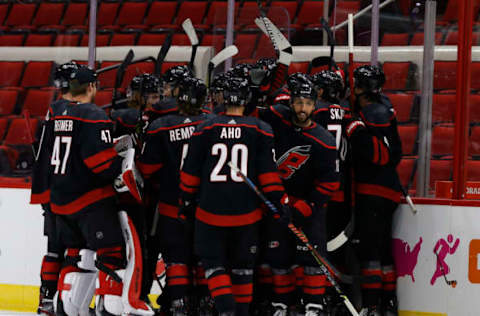 RALEIGH, NORTH CAROLINA – JANUARY 28: The Carolina Hurricanes celebrate after Martin Necas #88 scored the game-winning goal in overtime of their game against the Tampa Bay Lightning at PNC Arena on January 28, 2021 in Raleigh, North Carolina. (Photo by Jared C. Tilton/Getty Images)