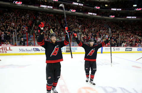 RALEIGH, NC – DECEMBER 31: Dougie Hamilton #19 of the Carolina Hurricanes celebrates with teammate Warren Foegele #13 after defeating the Montreal Canadiens during an NHL game on December 31, 2019 at PNC Arena in Raleigh, North Carolina. (Photo by Gregg Forwerck/NHLI via Getty Images)