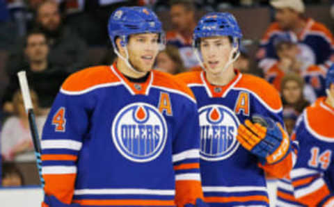 Nov 20, 2015; Edmonton Oilers forward Taylor Hall (4) and forward Ryan Nugent-Hopkins (93) talk between whistles (Perry Nelson-USA TODAY Sports)