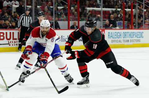 RALEIGH, NC – DECEMBER 31: Ryan Dzingel #18 of the Carolina Hurricanes and Shea Weber #6 of the Montreal Canadiens battle to control a loose puck during an NHL game on December 31, 2019 at PNC Arena in Raleigh, North Carolina. (Photo by Gregg Forwerck/NHLI via Getty Images)