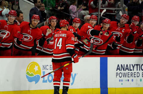 RALEIGH, NC – FEBRUARY 2: Justin Williams #14 of the Carolina Hurricanes scores the game winning goal in a shootout and celebrates with teammates in the bench area during an NHL game against the Vancouver Canucks on February 2, 2020 at PNC Arena in Raleigh, North Carolina. (Photo by Gregg Forwerck/NHLI via Getty Images)