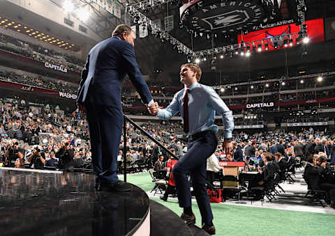 DALLAS, TX – JUNE 22: Alexander Alexeyev greets NHL commissioner Gary Bettman after being selected thirty-first overall by the Washington Capitals during the first round of the 2018 NHL Draft at American Airlines Center on June 22, 2018 in Dallas, Texas. (Photo by Brian Babineau/NHLI via Getty Images)