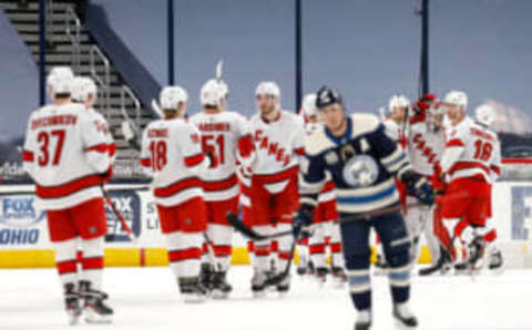 COLUMBUS, OH – FEBRUARY 7: Cam Atkinson #13 of the Columbus Blue Jackets skates off of the ice as James Reimer #47 of the Carolina Hurricanes is congratulated by his teammates after defeating Columbus 6-5 at Nationwide Arena on February 7, 2021 in Columbus, Ohio. Photo by Kirk Irwin/Getty Images)