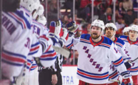 CALGARY, CANADA – FEBRUARY 18: Alexis Lafreniere #13 of the New York Rangers celebrates with the bench after scoring his team’s second goal to tie the game and force overtime against the Calgary Flames during the third period of an NHL game at Scotiabank Saddledome on February 18, 2023, in Calgary, Alberta, Canada. The Flames defeated the Rangers 3-2 in overtime. (Photo by Derek Leung/Getty Images)