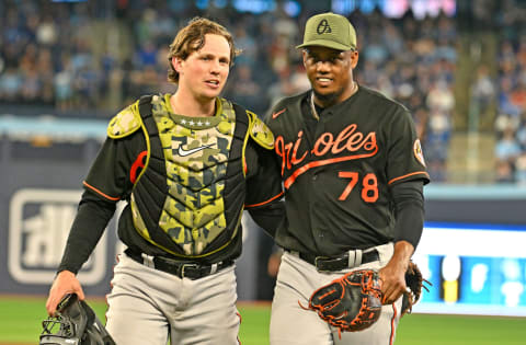 May 19, 2023; Toronto, Ontario, CAN; Baltimore Orioles catcher Adley Rutschman (35) and relief pitcher Yennier Cano (78) leave the field after the eighth inning against the Toronto Blue Jays at Rogers Centre. Mandatory Credit: Dan Hamilton-USA TODAY Sports