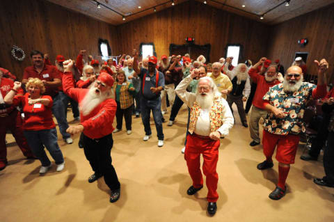 Santas practice their dance moves.