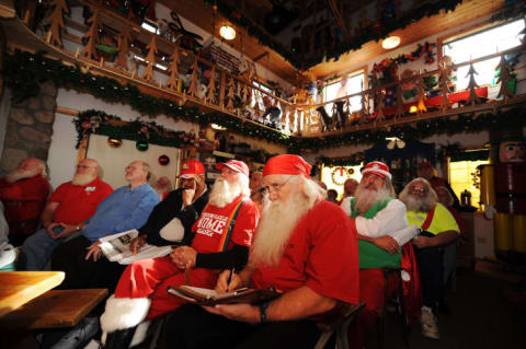 Santas take notes inside the "Santa House" in Midland, Michigan.