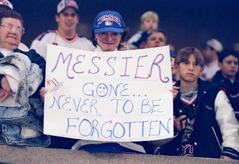 25 Nov 1997: Fans of center Mark Messier of the Vancouver Canucks hold up a sign during a game against the New York Rangers at Madison Square Garden in New York City, New York. The Canucks won the game 4-2.