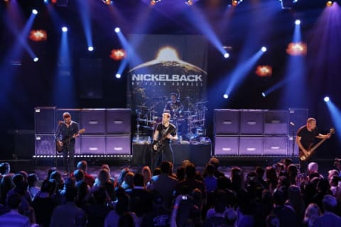 Nickelback's Ryan Peak, Chad Kroeger, Daniel Adair, and Mike Kroeger perform at the iHeartRadio Theater in 2014.