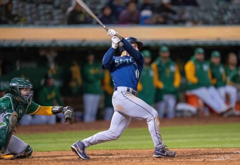 May 2, 2023; Oakland, California, USA; Seattle Mariners left fielder Jarred Kelenic (10) hits a RBI double during the eighth inning against the Oakland Athletics at RingCentral Coliseum. Mandatory Credit: Neville E. Guard-USA TODAY Sports