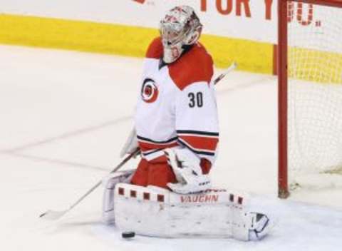 Feb 5, 2016; Winnipeg, Manitoba, CAN; Carolina Hurricanes goalie Cam Ward (30) makes a save during the second period against the Winnipeg Jets at MTS Centre. Mandatory Credit: Bruce Fedyck-USA TODAY Sports