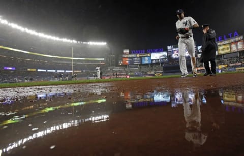 Sep 30, 2016; Bronx, NY, USA; New York Yankees right fielder Aaron Hicks (31) heads for the dugout in the rain during the fourth inning against the Baltimore Orioles at Yankee Stadium. Mandatory Credit: Adam Hunger-USA TODAY Sports