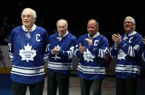 Toronto, Canada – February 21 – Armstrong (left) gets applause from Leafs Alumni Red Kelly, Wendell Clark and Rick Vaive.Prior to the Start of the game, the Leafs announced the induction of George Armstrong and Syl Apps to their Legends Row with an on ice ceremony. Syl Apps junior was on hand (left) with George Armstrong for a ceremonial puck drop.The Toronto Maple Leafs took on the Winnipeg Jets at the Air Canada Centre in Toronto.February 21, 2015 (Richard Lautens/Toronto Star via Getty Images)