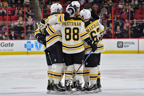 RALEIGH, NC – MARCH 13: Boston Bruins teammates surround Boston Bruins Right Wing David Pastrnak (88) after his third goal during a game between the Carolina Hurricanes and the Boston Bruins at the PNC Arena in Raleigh, NC on March 13, 2018. Boston defeated Carolina 6-4. (Photo by Greg Thompson/Icon Sportswire via Getty Images)